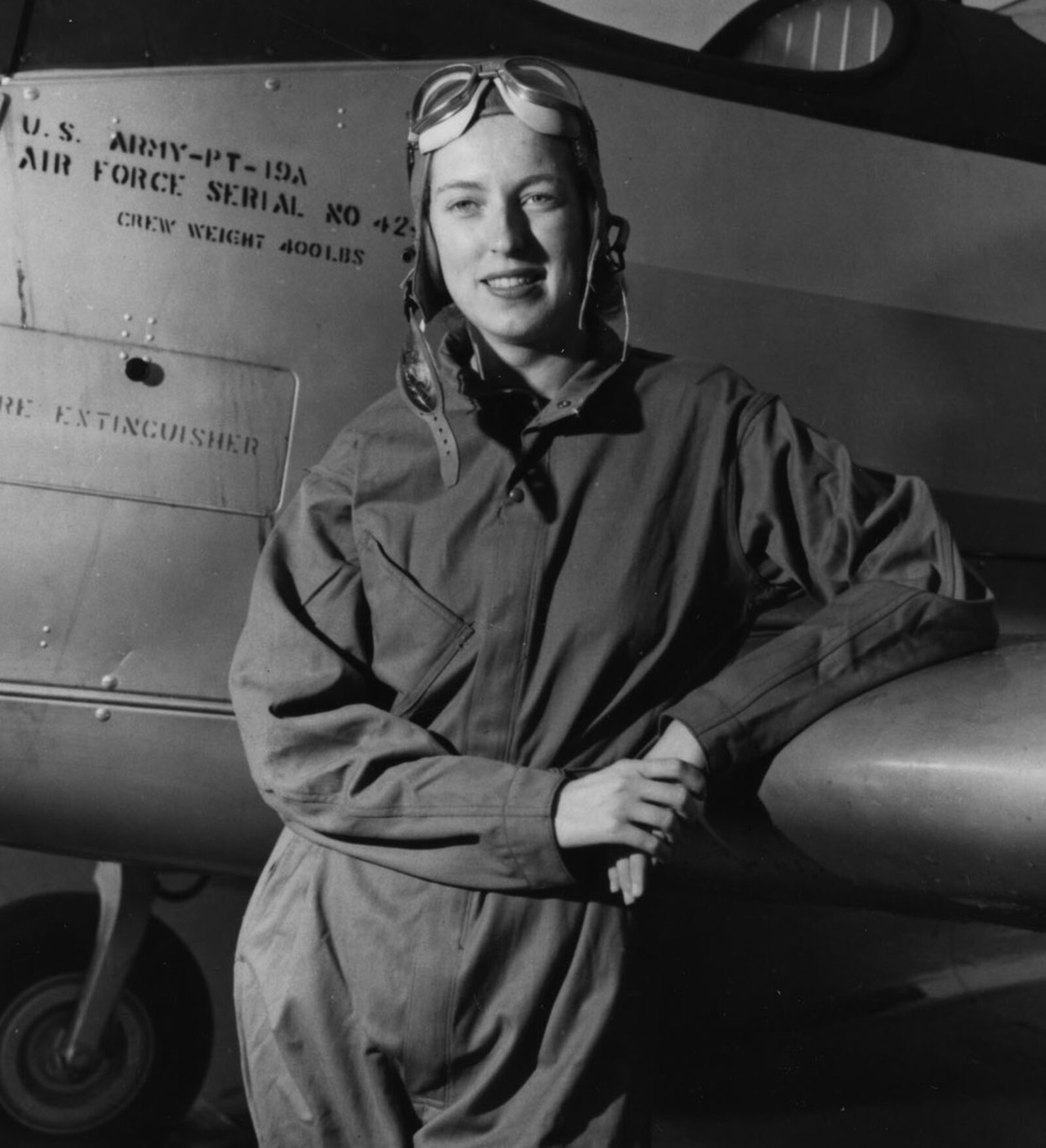 Cornelia Fort standing beside a PT-19A trainer aircraft